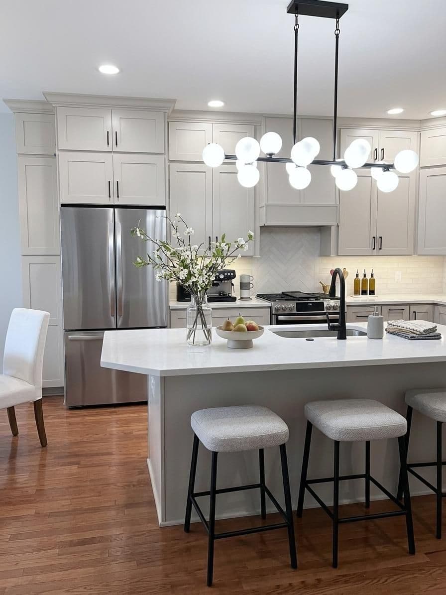Light grey kitchen remodel with sphere light fixture