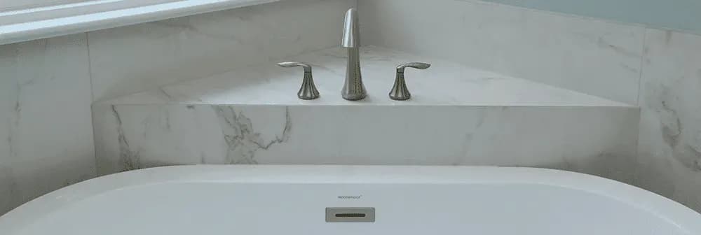 A close-up of a soaking tub in the corner of a bathroom.