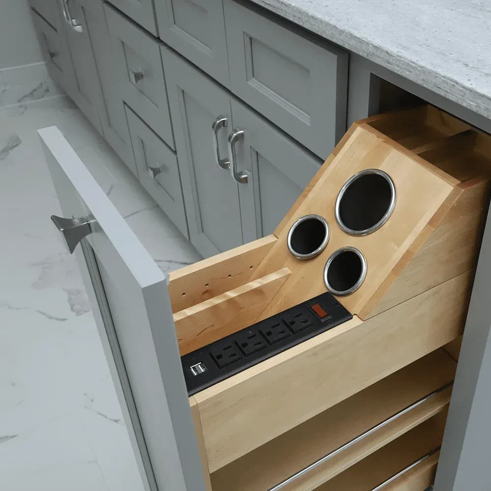 A custom vanity cabinet drawer with built-in electrical plugs and hairdryer holster.